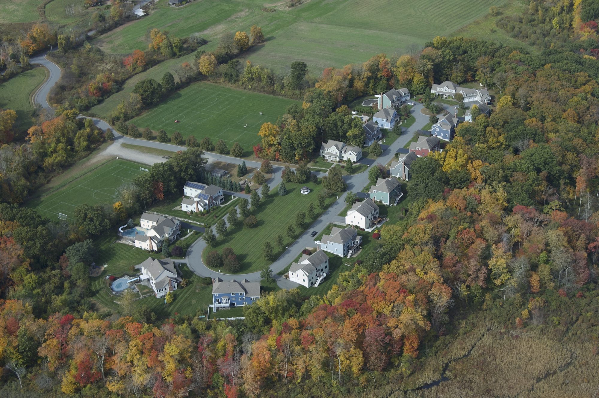 Wide aerial of Carter Field Road showing the homes, recreational fields, and surrounding farmland