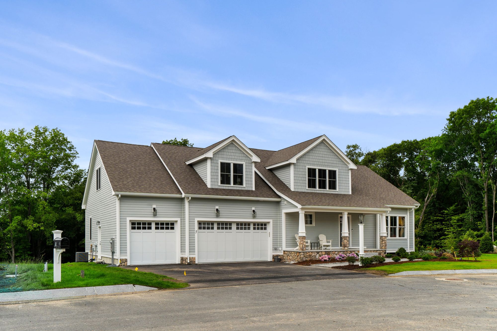 A Fieldstone Village home with light gray siding